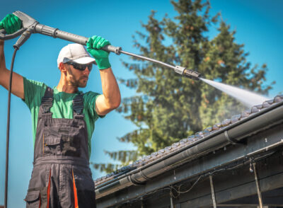 Washing Plastic Transparent Carport Roof by Caucasian Men. Pressure Washer Job.